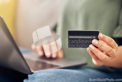 Image of Hands, credit card and laptop on sofa, home and closeup for online shopping, sale or payment with internet banking. Woman, pc and fintech app for cybersecurity, discount or deal with e commerce store