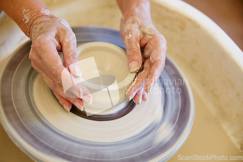 Image of Creating a masterpiece with her hands. Cropped shot of a woman making a ceramic pot in a workshop.