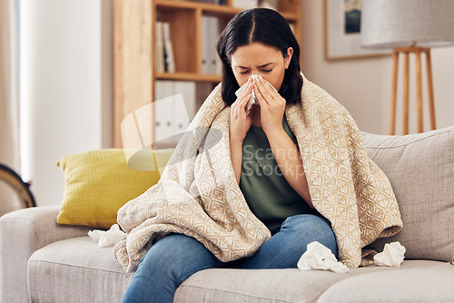 Image of Tissue, blow nose and woman on sofa for home self care with virus, sick and healthcare or allergies. Sinus, flu and person on living room couch with allergy for medical or health and wellness risk