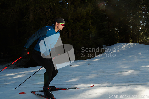 Image of Nordic skiing or Cross-country skiing classic technique practiced by man in a beautiful panoramic trail at morning.Selective focus.