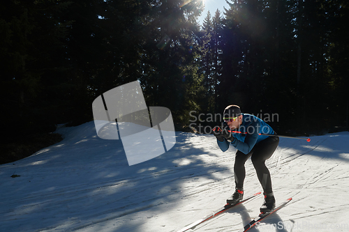 Image of Nordic skiing or Cross-country skiing classic technique practiced by man in a beautiful panoramic trail at morning.Selective focus.