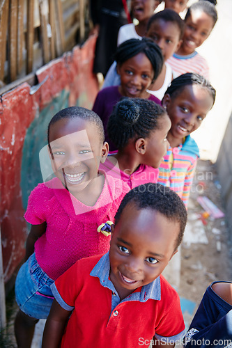 Image of They always seem to be smiling. Cropped portrait of a group of kids at a community outreach event.