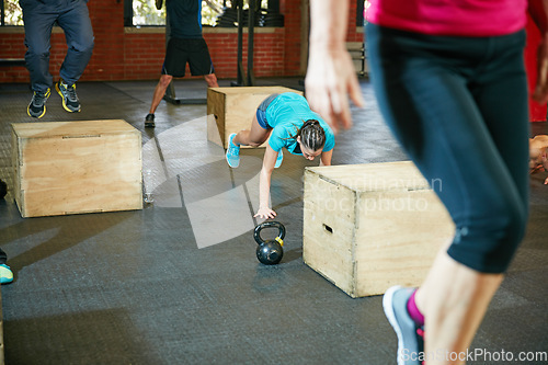 Image of Push harder, get stronger. Shot of a young woman doing push ups during her workout at the gym.