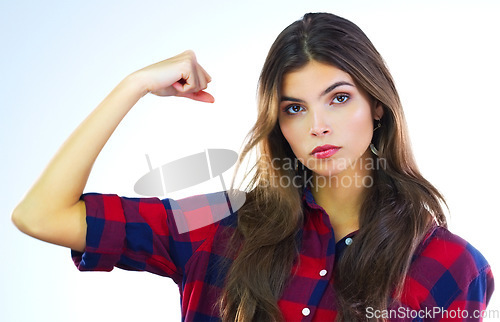 Image of Im not just a woman, Im a strong woman. Cropped shot of a young woman flexing her muscles against a white background.