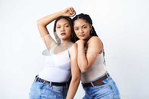 Image of Confidence is beautiful. Studio shot of two beautiful young women posing against a grey background.