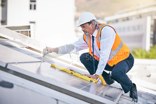 Image of Solar panels, engineering man and tools in maintenance, energy saving builder and rooftop electrician services. Grid, screwdriver and technician or contractor person for eco photovoltaic installation