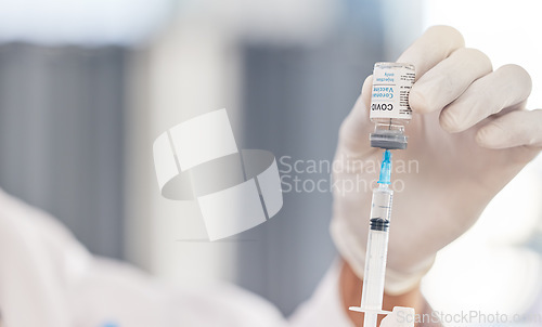 Image of Doctor, hands and syringe for covid vaccine, virus and pharmacy medicine, hospital or clinic service. Medical, compliance or healthcare professional or nurse with needle and corona virus glass bottle