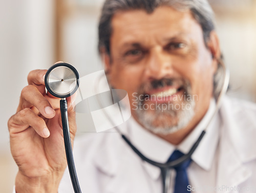 Image of Man, portrait and a doctor with a stethoscope for healthcare, consultation or medical test. Happy, hospital and a mature male nurse or surgeon with gear for a clinic, cardiology or nursing exam