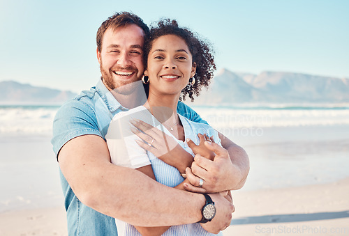 Image of Beach, love and portrait of couple hugging in nature, holiday or romantic outdoor date together at the ocean, sea or sand. Happy, smile and people in a hug, embrace or happiness on anniversary