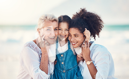 Image of Mother, grandmother and a child portrait at the beach while on a family vacation, holiday or adventure. A senior woman, mom and girl kid together with a smile while outdoor for summer fun and travel