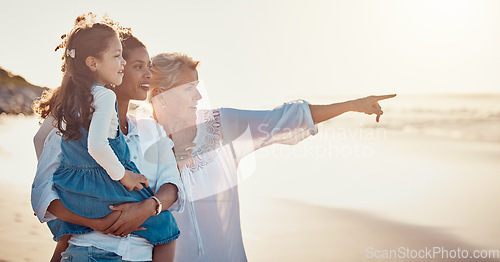 Image of Family, summer and vacation while pointing at the beach on holiday or adventure together. Women or a mother and grandmother with a girl kid outdoor for fun, happiness and learning about nature