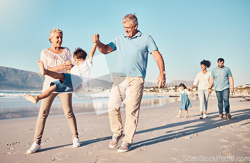 Image of Swinging, grandparents and a child walking on the beach on a family vacation, holiday or adventure in summer. Young boy kid holding hands with a senior man and woman outdoor with fun energy or game