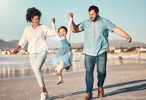 Image of Happy family, swinging and a child at the beach on vacation, holiday or adventure in summer. Young girl kid holding hands and playing with parents outdoor with fun energy, happiness and love at sea