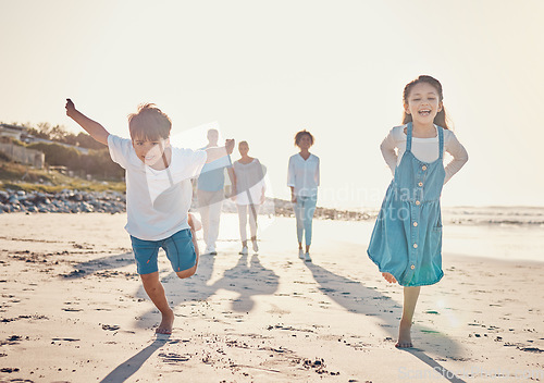 Image of Happy, excited and children playing on the beach on family vacation, holiday or adventure in summer. Young girl and boy or kids and parents outdoor with fun energy and happiness while playing a game