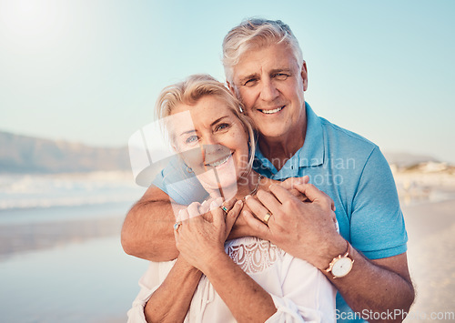 Image of Beach, love and portrait of senior couple hugging in nature, holiday or romantic outdoor date together at the ocean, sea or sand. Happy, smile and people in a hug, embrace or happiness on anniversary