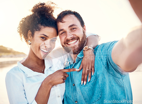 Image of Selfie, holiday and happy couple celebrate engagement, marriage and beach memory on social media. Digital photography, man and woman relax on ocean vacation together with smile, love and wedding ring