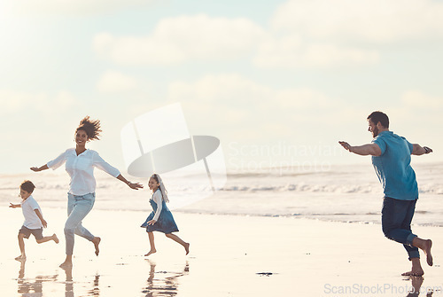 Image of Mother, father and children on the beach to dance together while outdoor for travel or vacation in summer. Sunset, family or children and siblings having fun with parents on the coast by the ocean