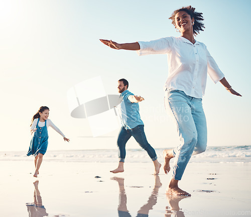 Image of Mother, father and daughter on the beach to dance together while outdoor for travel or vacation in summer. Sunset, family or children and a girl having fun with her parents on the coast by the ocean