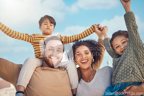 Image of Portrait, motivation and piggyback with a family cheering together against a blue sky. Diversity, love or smile with happy parents and children in the garden of their home for trust or support