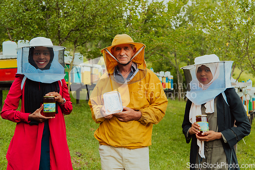 Image of Portrait of Arab investors with a beekeeper in a large honey production farm