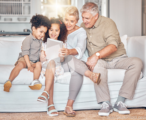 Image of Social media, children and grandparents with tablet in a house, streaming cartoon or movie online. App, smile and interracial kids and senior man and woman with technology for a film, game or website