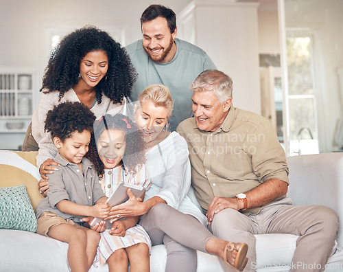 Image of Big family, tablet and children in home, happy and bonding together in living room. Technology, multiracial kids and grandparents with parents in lounge streaming movie, video or film on social media