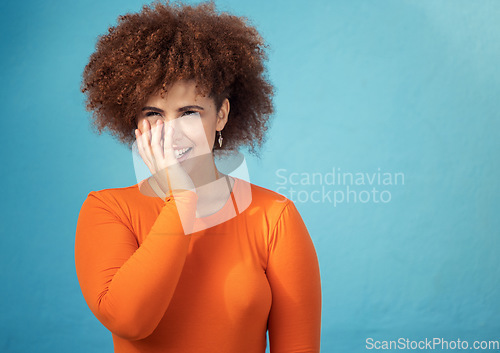 Image of Happy, shy and young woman in studio with a positive, optimistic and innocent mindset. Happiness, giggle and excited female model from Mexico with smile posing while isolated by turquoise background.