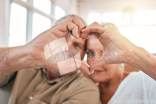 Image of Senior couple, heart hands and love for support, care or trust in compassion or relationship at home. Closeup of elderly man and woman touching hand together for loving emoji, symbol or sign in house