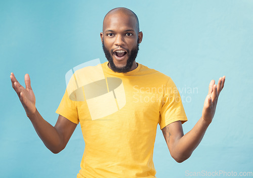 Image of Portrait, wow and surprise with a black man in studio on a blue background feeling shocked or in awe. Announcement, news or gesture and a surprised male looking on in wonder with an omg expression