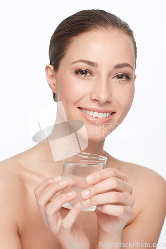 Image of Hydration is key. A beautiful woman with bare shoulders holding a glass of water.