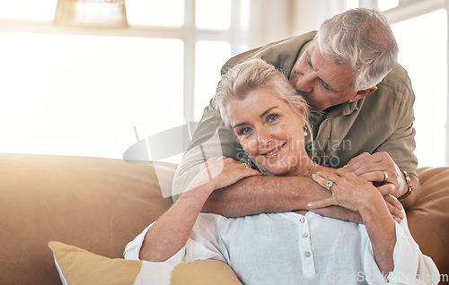 Image of Senior, portrait and a couple kiss and hug on the living room sofa for love, care and bonding. Happy, house and an elderly man and woman with romance together for gratitude, retirement and kindness