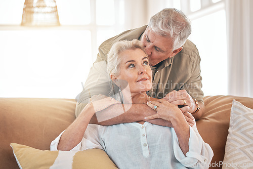 Image of Old couple, hug and kiss with retirement together, love and care in marriage with people at home. Relax in living room, life partner and pension, man and woman bonding with trust and commitment