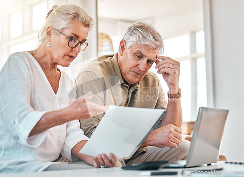 Image of Senior couple, documents and financial crisis in debt, expenses or budget planning at home. Elderly woman and frustrated man working together on finance paperwork, debit order or retirement report