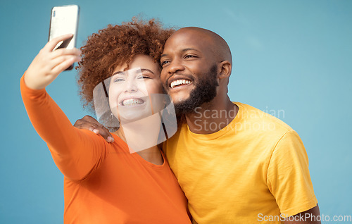 Image of Couple, hug or bonding selfie on blue background, isolated mockup or wall mock up for social media. Smile, happy or black man and afro woman on photography technology for interracial profile picture