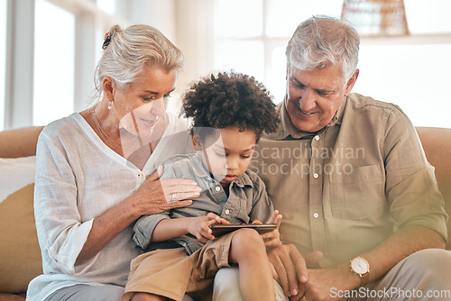 Image of Phone, grandparents and child in home, happy and bonding together in living room. Smartphone, interracial kid and grandpa and grandma in lounge streaming movie, video or internet film on social media