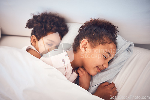 Image of Girl, sleeping and children in bed in home with peace, comfort and rest with sisters, girls or friends together in bedroom. Kids, sleep and dream with happiness with pillow, blanket and duvet