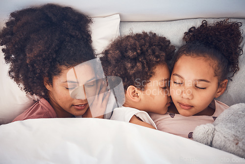 Image of Mother, children and sleeping in bed together at home for security, bonding and comfort. Healthy, peace and a woman and kids nap, dream and rest or relax in a bedroom with love, care and safety