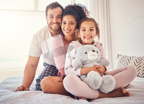 Image of Portrait, bed and family with love, happy and relax with quality time, bonding and home with care. Parents, mother and father with child, bedroom and kid with mom, dad and happiness on weekend break