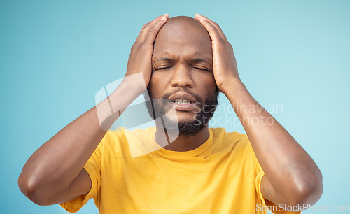 Image of Fail, mistake and mental health with a black man in studio on a blue background feeling stress or anxiety. Compliance, burnout and oops with a handsome young man posing hands on head on a pastel wall