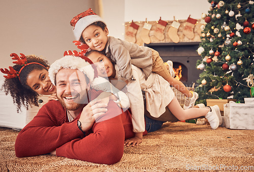 Image of Christmas, portrait and happy family in home on floor, bonding and together. Xmas, smile and face of parents with children, interracial and African mom with father for party, celebration or holiday