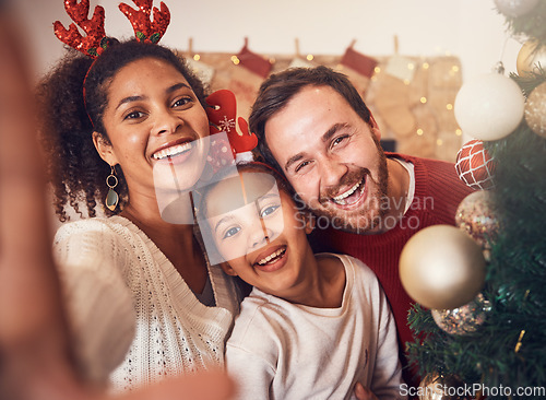 Image of Christmas, happy family and portrait, selfie and funny together in home. Xmas, smile and face of parents with girl, interracial and African mom laughing with father for party, celebration and holiday