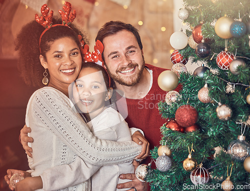 Image of Christmas, happy family and portrait in home, hug and bonding together. Xmas, smile and face of parents with girl, interracial kid and African mom embrace father for party, celebration and holiday