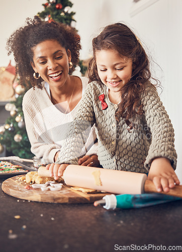Image of Kid, baker and mother on christmas with happiness for teaching on kitchen counter for lunch. Smile, child and learning with cookies with parent for festive season in home with bond or development.