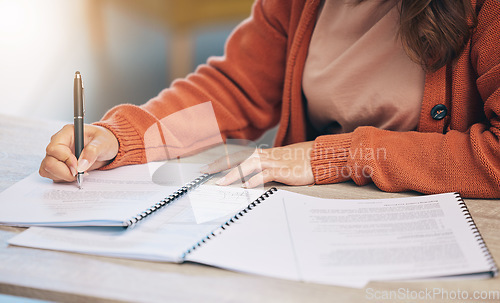 Image of Woman, hands and writing on documents for signing contract, form or application on desk at home. Closeup of female person working on paperwork, notes or filling in survey for legal agreement or deal