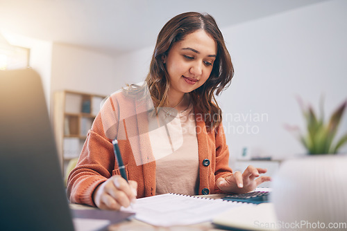 Image of Remote work from home, woman writing and laptop with finance, budget planning and startup. Female person, entrepreneur or accountant with documents, lounge or check paperwork with focus or connection