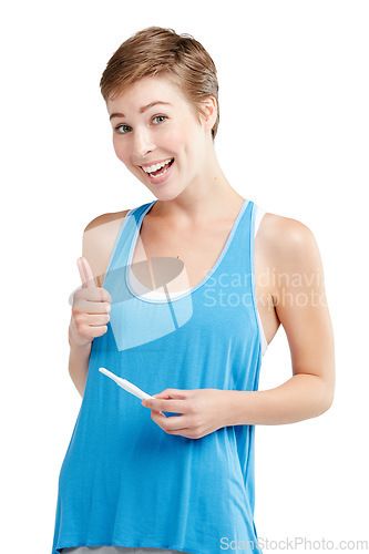 Image of Portrait, thumbs up and pregnancy test with a woman in studio isolated on a white background for prenatal health. Pregnant, positive and emoji with an attractive young mother to be on blank space