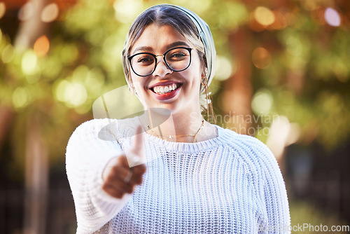 Image of Young woman, thumbs up in portrait and smile, agreement and yes emoji with like sign and happiness. Deal, support and positive feedback, female person with review and good luck, opinion and vote