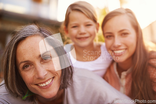 Image of The girls enjoying some morning sunlight. Portrait of a grandmother, mother and granddaughter.