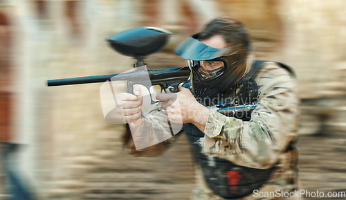 Image of Paintball gun, gear or man shooting competition, aim and target soldier, warrior or action player in battlefield game arena. Outdoor blur, rifle or male shooter focus on battle, conflict or challenge