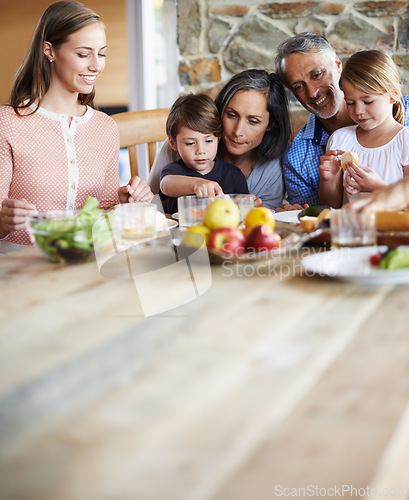 Image of Healthy, nutritious and delicious. A happy multi-generational family sitting at a table and having lunch together.